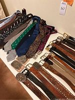 Overview of belts and ties laid out on table
