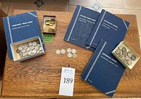Overview: Mercury dimes album, Lincoln cents album, two Jefferson nickel albums, loose dimes and casino tokens on table
