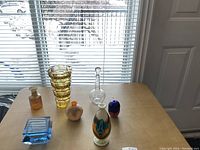 Seven glass pieces on table in front of window showing overall assortment