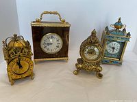 Four clocks displayed side by side on white background