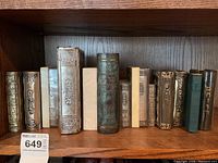 Wide shelf view showing all 13 volumes in the lot