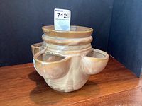 Photo showing front angle view of McCoy brown herb planter with central and side pots.