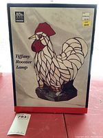 Photo of the original box showing the Tiffany Rooster Lamp by Home Styles with price tags and label details.