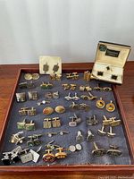 Full tray of assorted unbranded and designer cufflinks on display