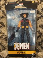 Front view of sealed Marvel Legends Weapon X figure showing the figure inside package with claws and costume details visible.