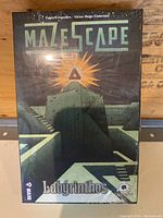 Front of the sealed Mazescape Labyrinthos board game box showing maze pyramid art and the game title.