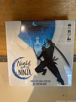 Front view of the sealed Night of the Ninja board game box showing ninja silhouette and game title.