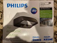 Box showing Philips branding and LED Wall Sconce image, highlighting economic and architectural blend features.