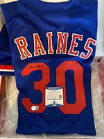 Blue signed Montreal Expos jersey showing the full back with RAINES and number 30, along with Beckett Certificate of Authenticity.