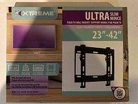 Photo of the front of the Xtreme Ultra Slim TV wall mount box showing compatibility with 23-42 inch TVs, weight capacity 88 lbs, and fixed mount type.