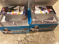 Two open Upper Deck branded boxes filled with hockey cards from Series 1 and Series 2, showing multiple stacks of cards with front images of various hockey players.