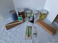 Whole lot showing candles, diffuser, wick trimmer, wick dipper, and candle holder on white surface