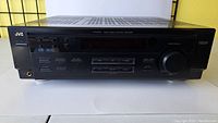 Front view of JVC RX-6010V receiver showing main control panel and volume knob.