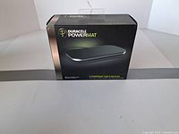 Boxed Duracell Powermat wireless charger, front view of the packaging showing product name and product image.