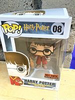 Front view of unopened Harry Potter Pop Vinyl box showing figure inside and Hot Topic exclusive sticker.