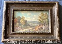 Framed oil painting by Aden F. Arnold showing a country landscape with trees, pathway, and hills under a cloudy sky.