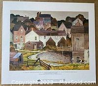 Photo of the A.J. Casson 'Saturday Afternoon' print showing the full printed image of a village scene with various houses and fenced pond.