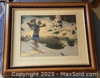 Framed print showing a winter hunting scene with a hunter on skis in snow holding a bow, signed by Arthur Heming in bottom right.