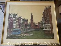 Framed limited edition print showing canal and buildings, signed and numbered at bottom right corner.