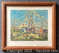 Framed print showing landscape scene with houses and sunlight shadows, attributed to David Milne from the McMichael Collection.