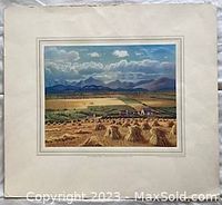 Full view of the unframed landscape print showing fields, haystacks, buildings, and mountains under clouds.