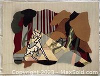 View of the textile artwork showing abstract layered fabric shapes in earth tones forming a nature scene.