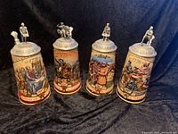 Set of 4 Miller Genuine Draft Birth of a Nation beer steins showing front view with detailed historical scenes and pewter lids topped by figures.