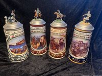 Set of four Civil War series collectible beer steins showing full designs and figurine lids.