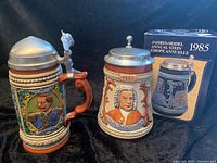 Two German lidded collectible steins, one featuring Kaiser Wilhelm II and the other Johann Sebastian Bach with original box.