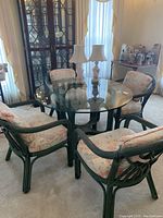 Full set showing round table and four chairs with floral cushions in living room