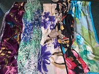 Five vintage scarves laid out showing color and design variety