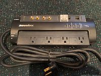 Top view of the black Panamax power strip showing 6 power outlets, 3 coaxial connectors, and power switch.