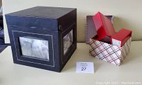 Overall view of the black decorative memory box and plaid cardboard box with three red photo albums
