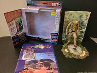 Locke figurine with its original packaging opened, island scenery base, and a brochure included.