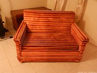 Front view of loveseat sofa bed showing copper and tan striped upholstery and straight arms.