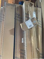 Stack of multiple sealed Cal Bamboo flooring cartons in garage