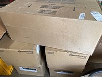 Stacked cardboard boxes marked Armstrong Ceilings Bethesda Grenoble model, each box 40 ceiling tiles, 12x12 inch size.