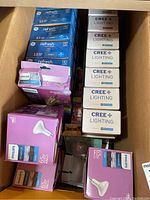 Photo showing multiple boxed LED bulbs from Philips and Cree in cardboard box.
