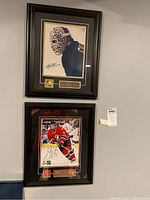 Framed plaques of Gerry Cheevers and Sidney Crosby hung on a wall.