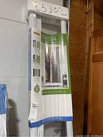Front view of Brisa retractable screen door packaging showing branding and product image.