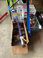 Overview of lot showing Shop-Vac box, Wagner Smart Roller box, blue level, and cardboard box with painting and hardware items