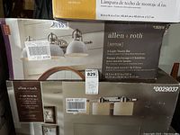 Photo showing two boxed Allen & Roth 3-light vanity bars with model numbers 1362618 and 0029037 visible.