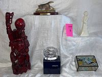 Full lot shown including red carved wood statue, Mikasa glass dish, animal figurines, stained glass box, and white lady figurine