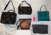 All five purses arranged on white backdrop, showing variety in styles and colors including black patent leather, teal leather, woven rattan, black studded leather, and dark grey suede.