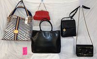 Full view of the 5 purses arranged on a white background, showing Tommy Hilfiger striped tote, black Longchamp tote, red clutch, black Jennifer Moore crossbody, and LJ Simone chain bag