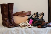 Overview photo showing six pairs of women's shoes including brown leather boots, white thong sandals, navy T-strap heels, brown flats, black lace-up oxfords, and black shoes with brown cap toe.