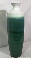 Front view of tall ceramic vase showing entire body with green gradient glaze transitioning to white at the rim.