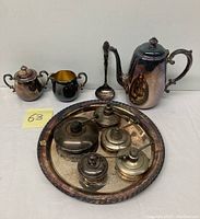 Full view of all items including teapot, sugar bowl, creamer, ladle, serving tray, and four chafing fuel pots.