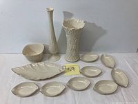 Full set of vintage Lenox porcelain including vases, large leaf dish, small leaf dishes, and a square bowl arranged on table.