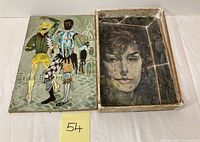 Two vintage oil on masonite paintings shown side by side; left painting depicts two male dancers in colorful attire, right painting is a portrait of a woman.